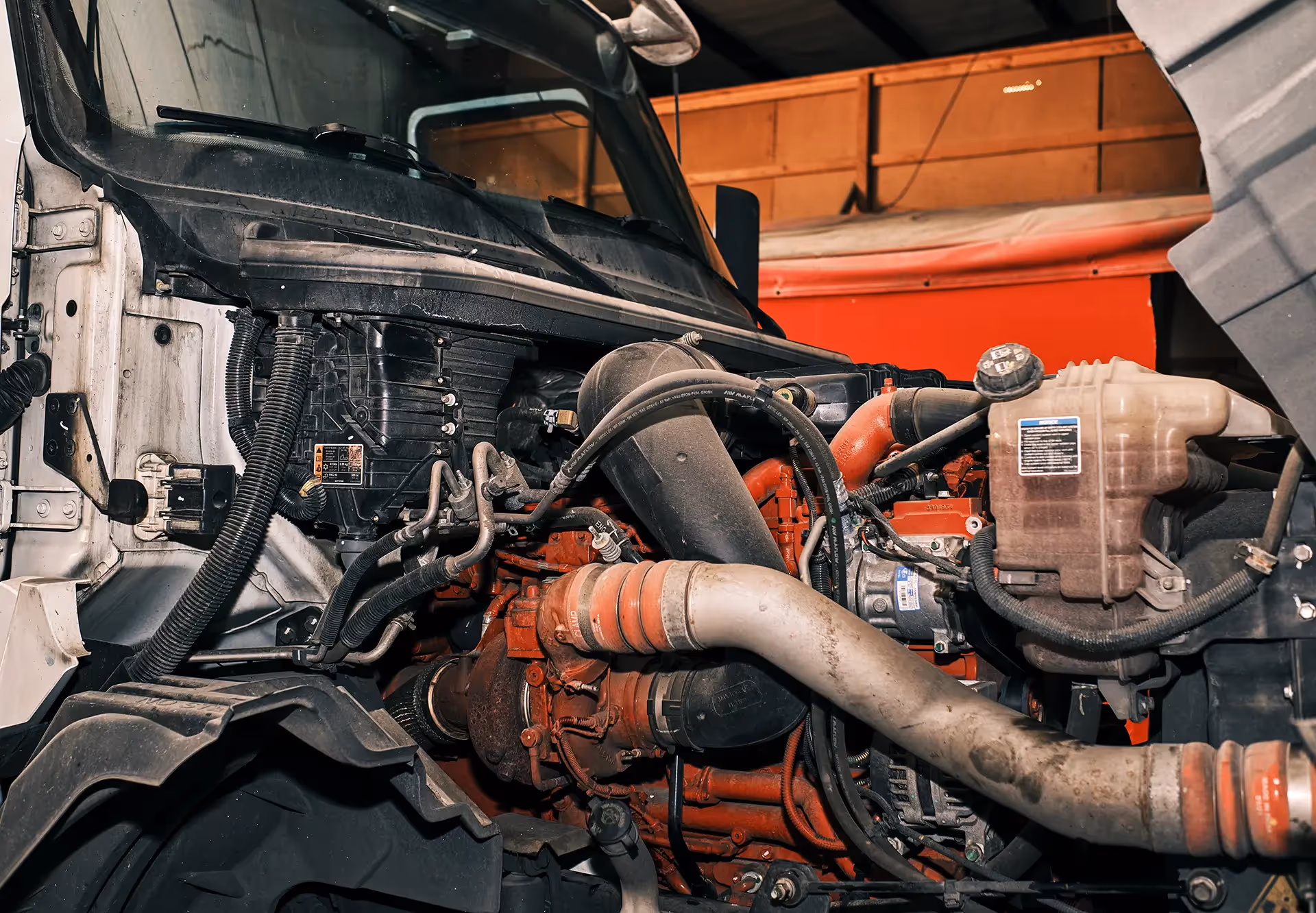 Mechanic performing truck coolant systems repair from SOS Truck & Trailer Repair