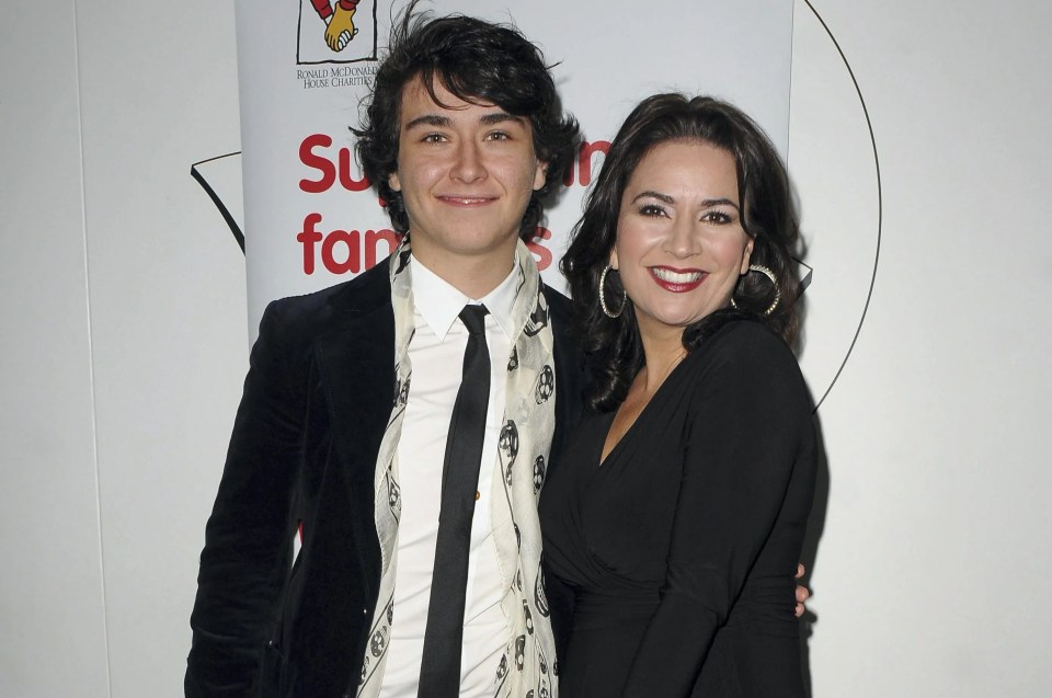 A man and woman standing together, smiling at the camera.