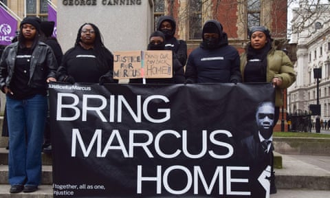 Protesters with a sign reading 'Bring Marcus home'