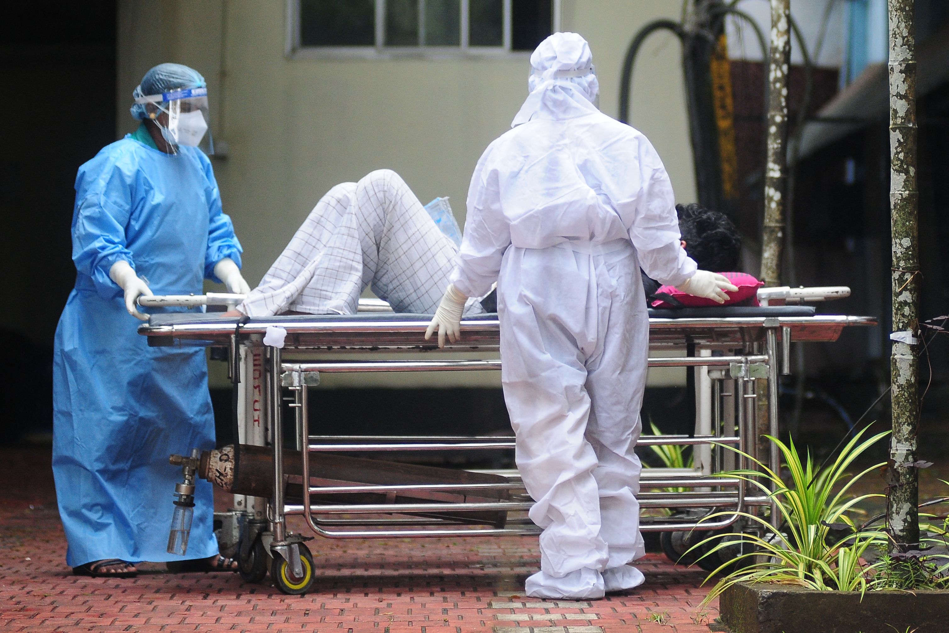 File. Health workers wearing protective gear shift a man with symptoms of Nipah virus to an isolation ward at a government hospital in Kozhikode in the south Indian state of Kerala on 16 September 2023