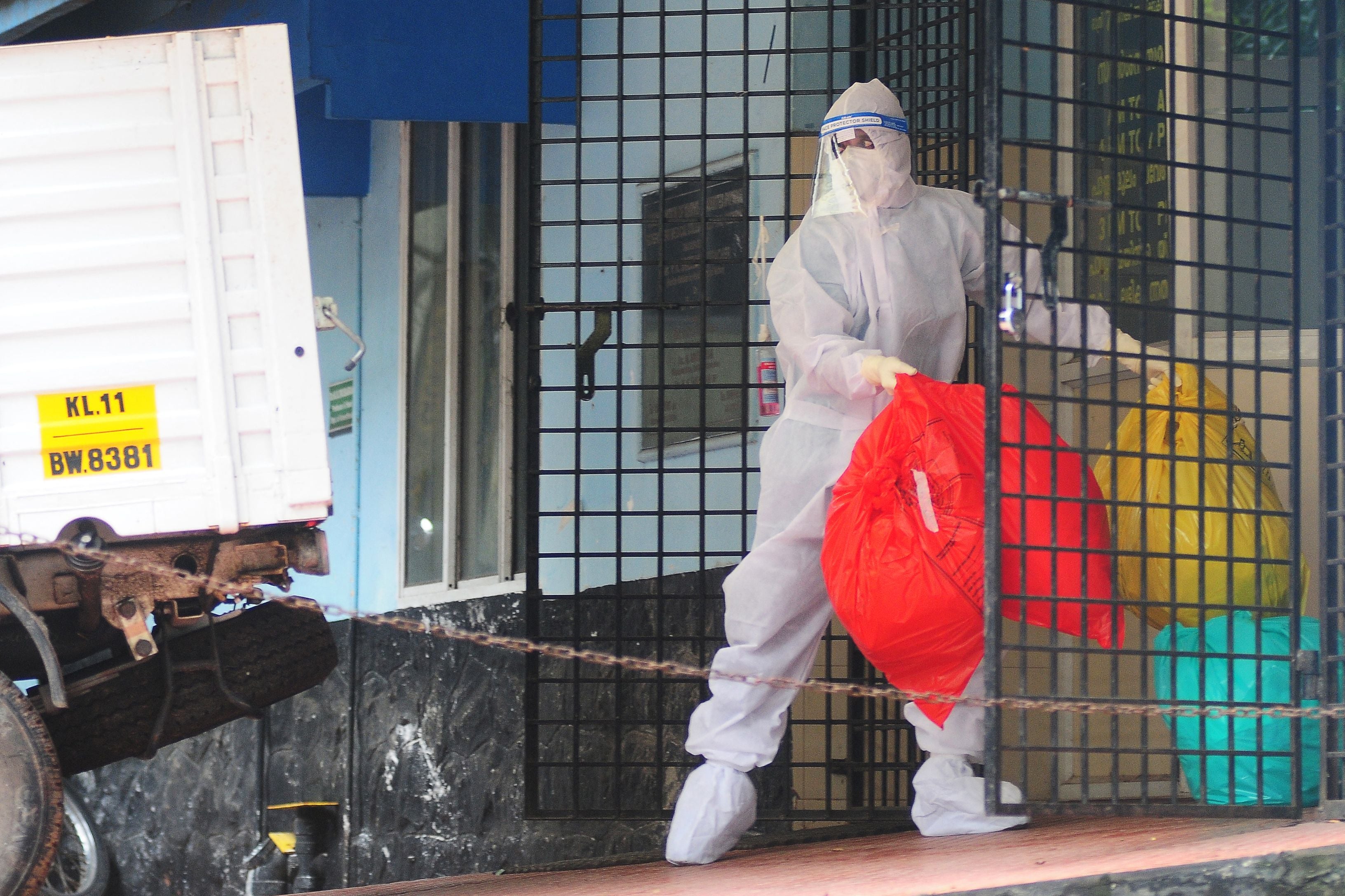 File. A health worker wearing protective gear disposes of biohazard waste from a Nipah virus isolation centre at a government hospital in Kozhikode, in India's southern state of Kerala, on 16 September 2023