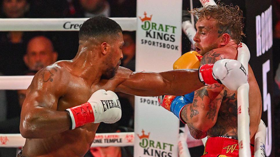 Anthony Joshua throws a left hook against Jake Paul