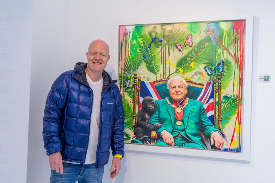 Jake Wood stands beside a pop art style painting of David Attenborough.