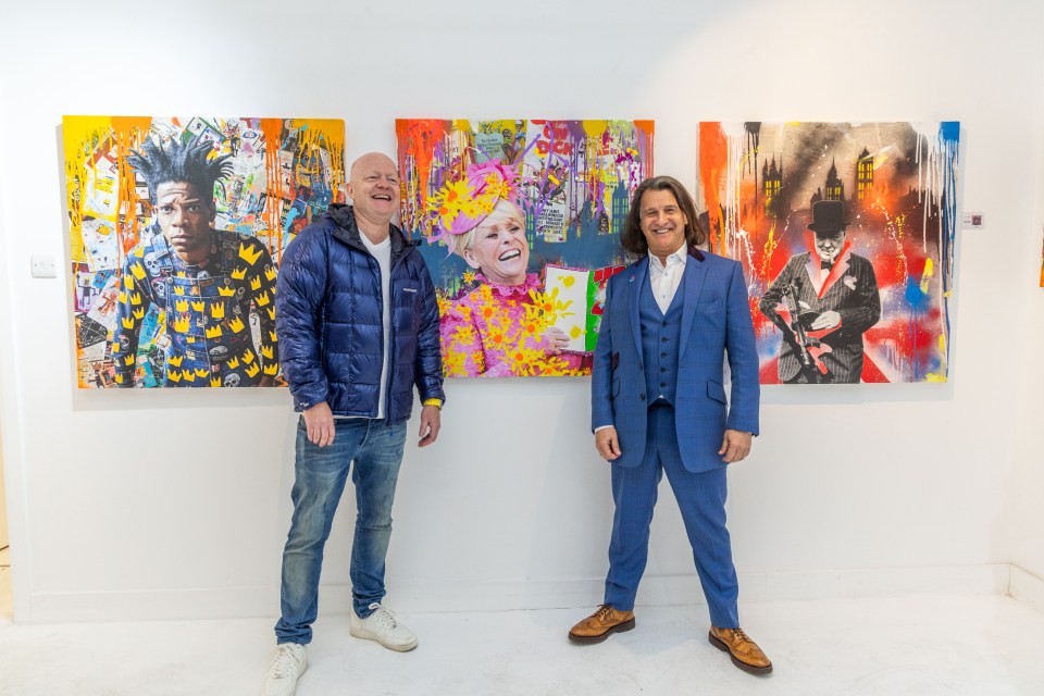 Jake Wood and Scott Mitchell posing in front of three colorful art pieces.