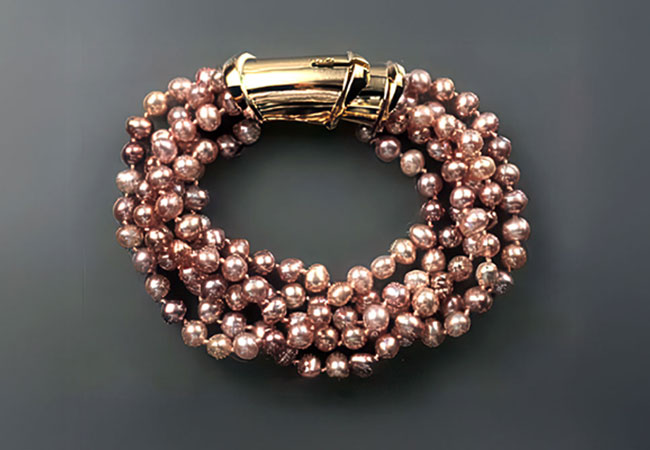 Twisted multi-strand pearl bracelet with gold clasp