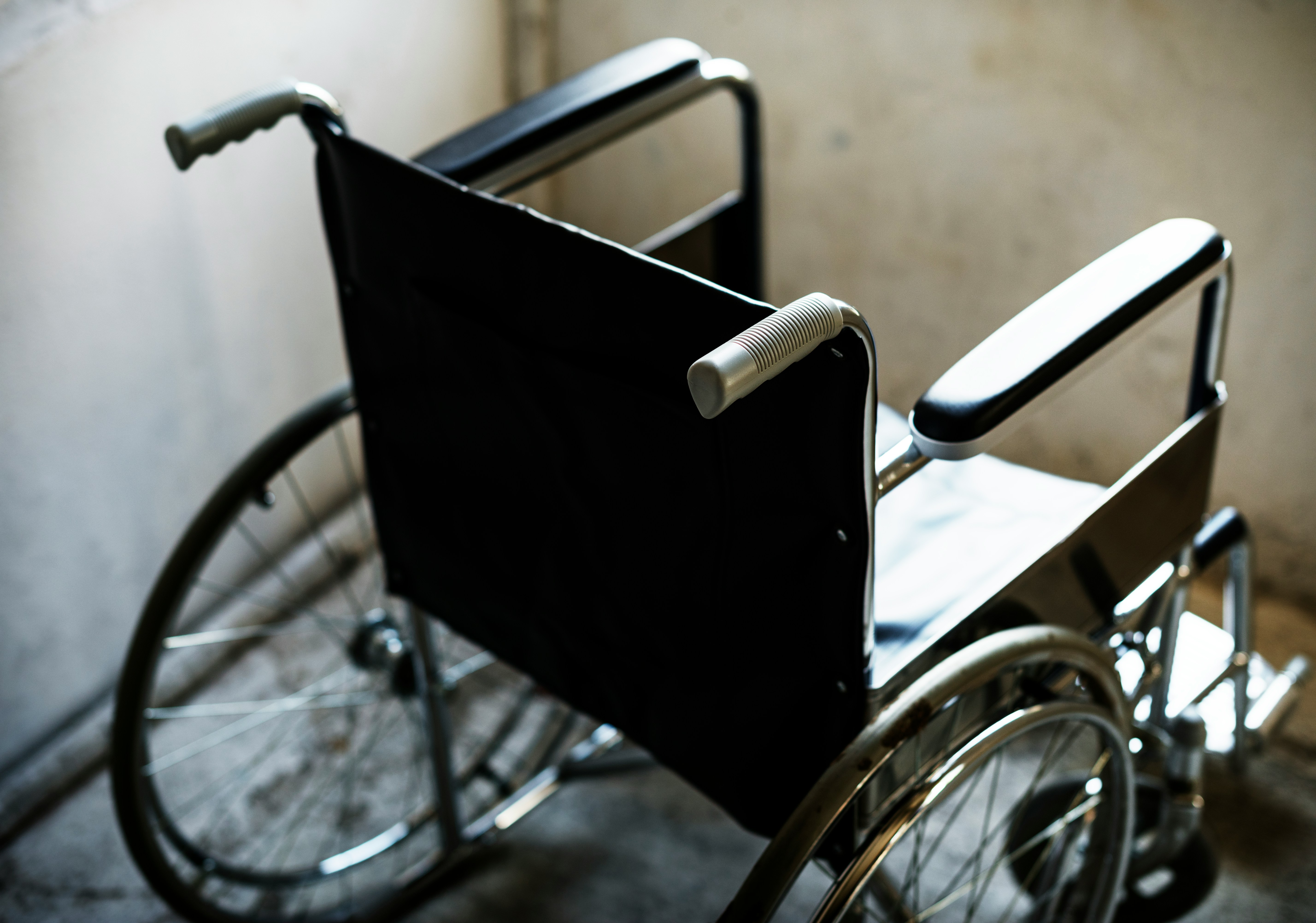 View of empty wheelchair from above behind right.