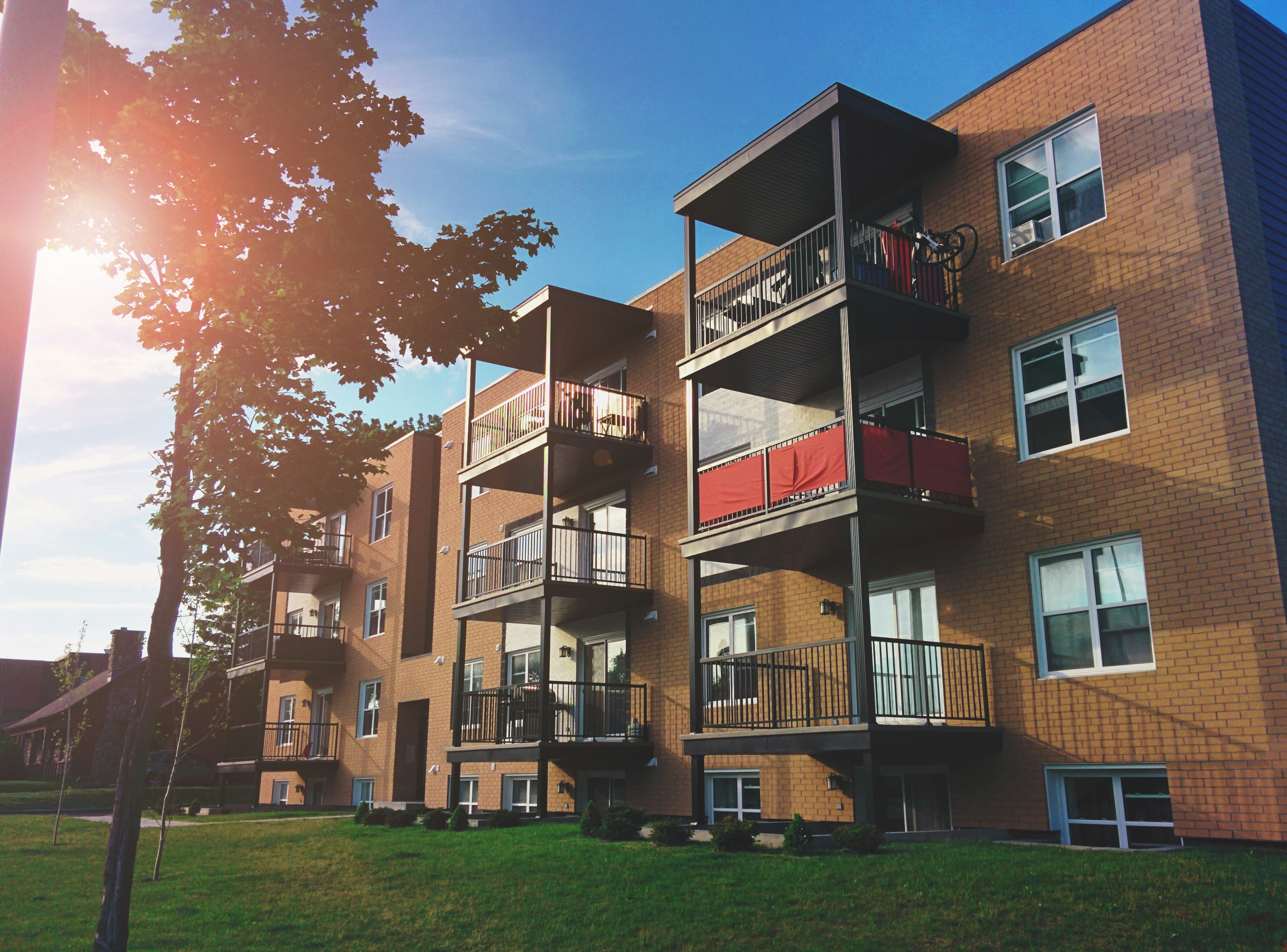 Brown brick apartment building exterior. Photo by Sigmund on Unsplash