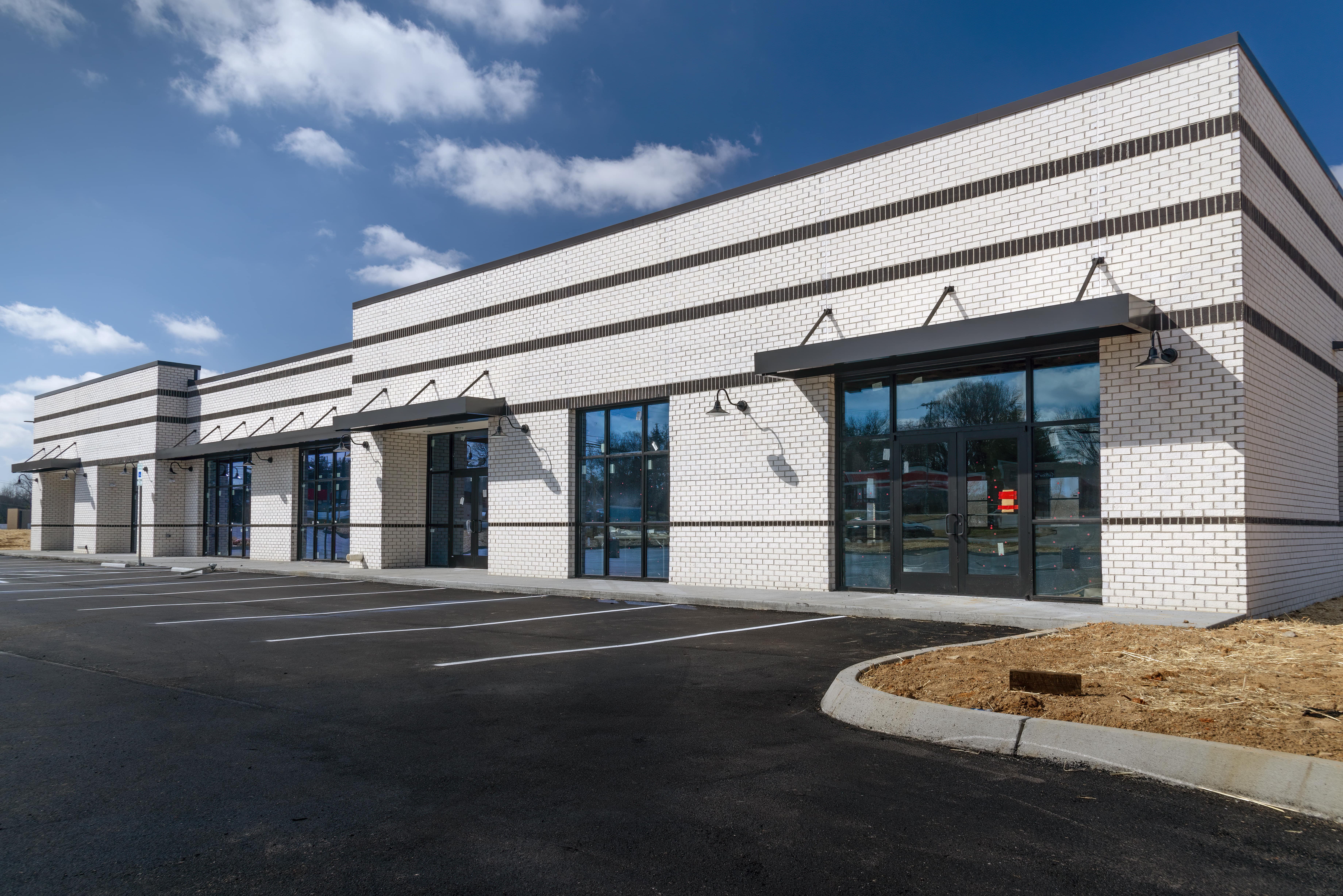 White brick retail building exterior.
