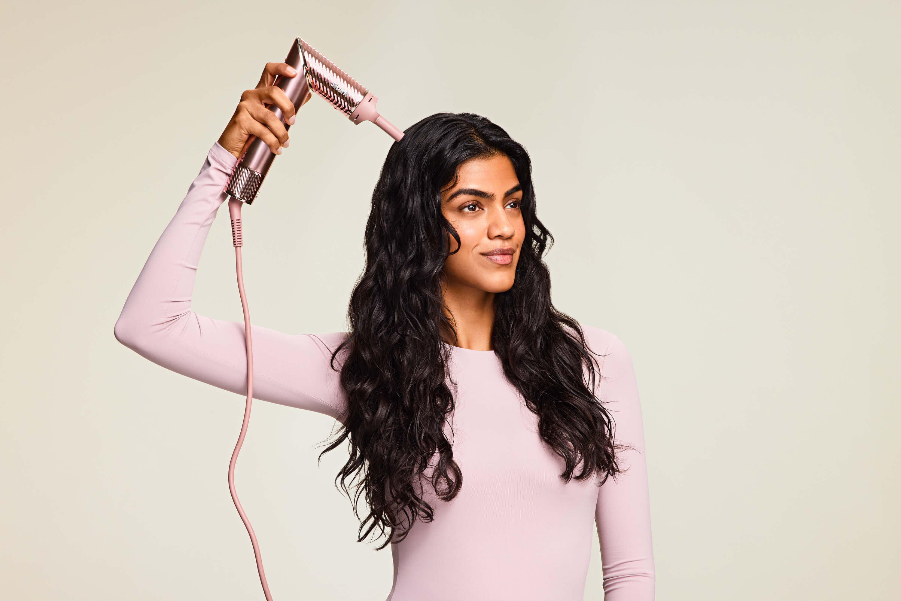Beauty photo of model using Shark Beauty hair dryer attachment, photo retouching by GentleRetouch.