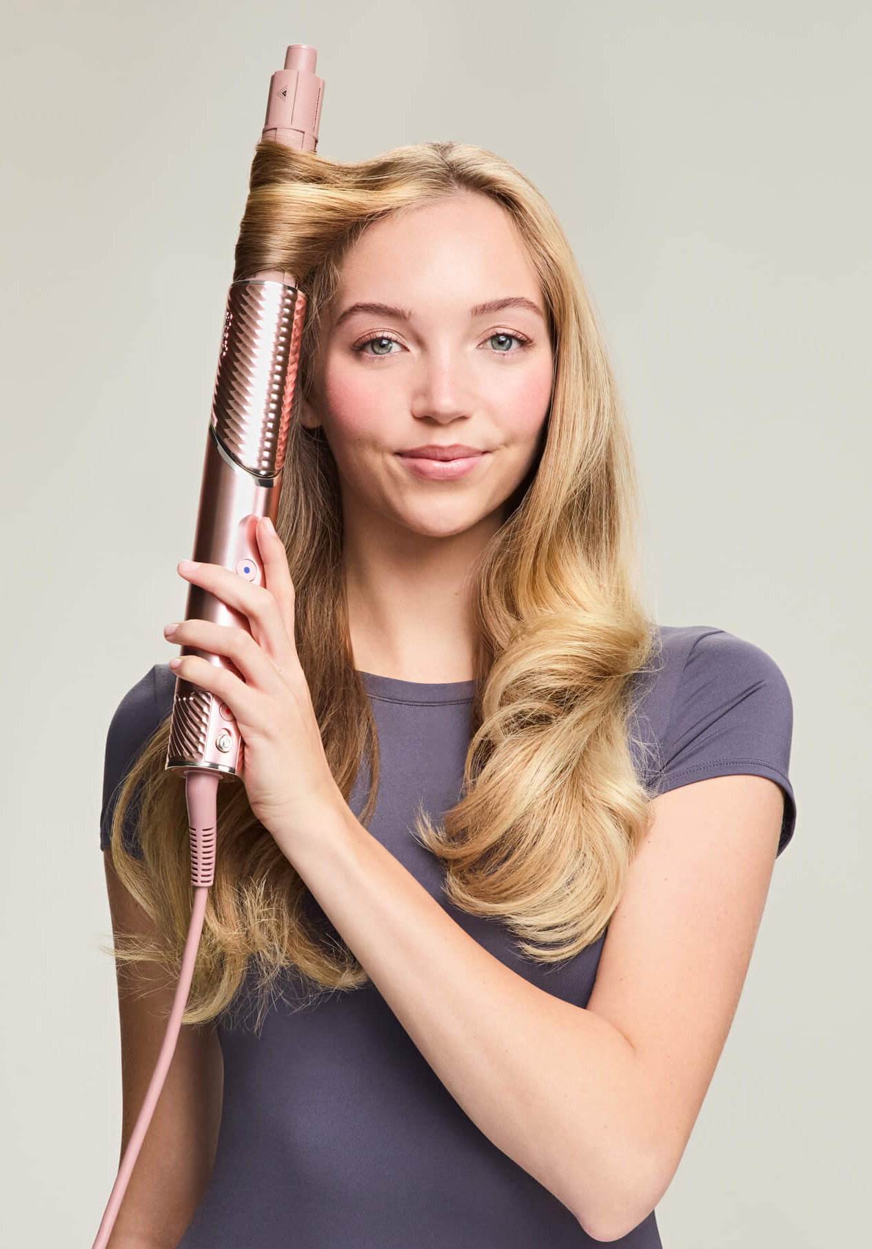 Beauty photo of model using Shark Beauty hair styler, photo retouching by GentleRetouch.