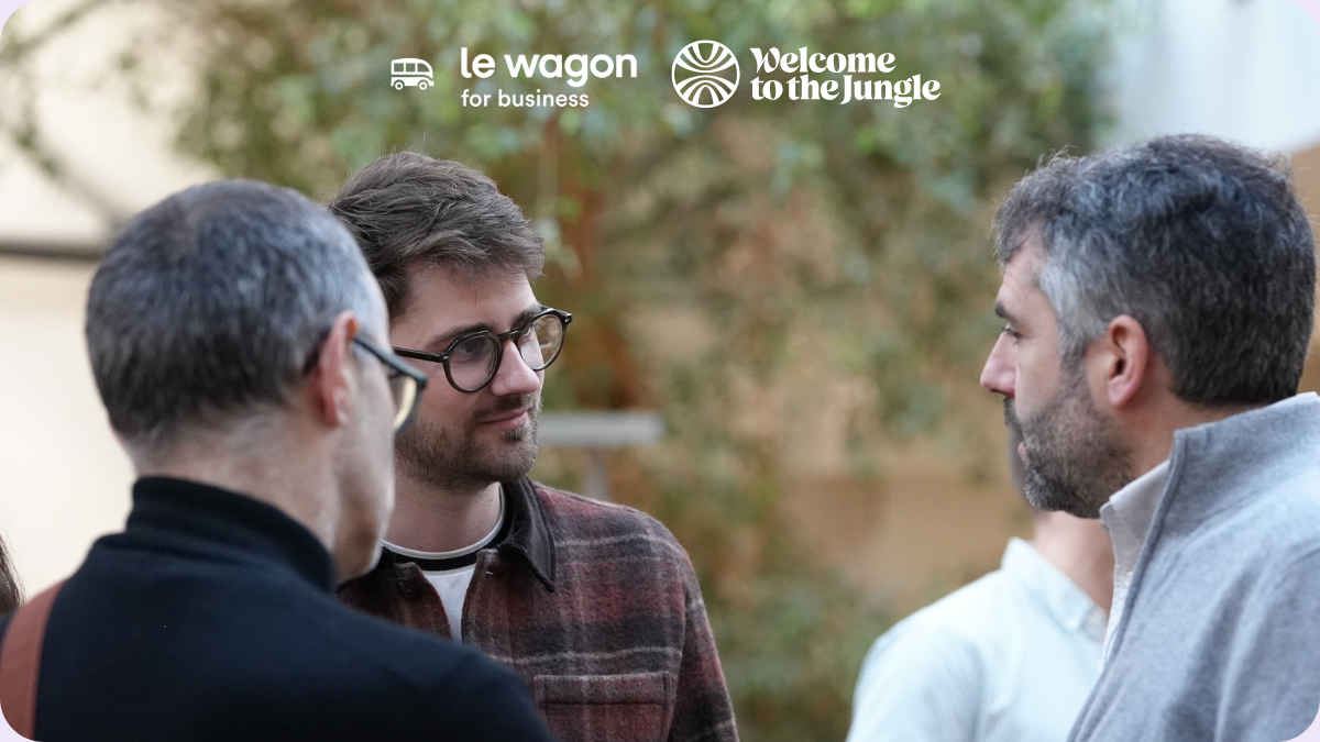 Three people engaged in conversation at a C-Level networking event at Le Wagon.