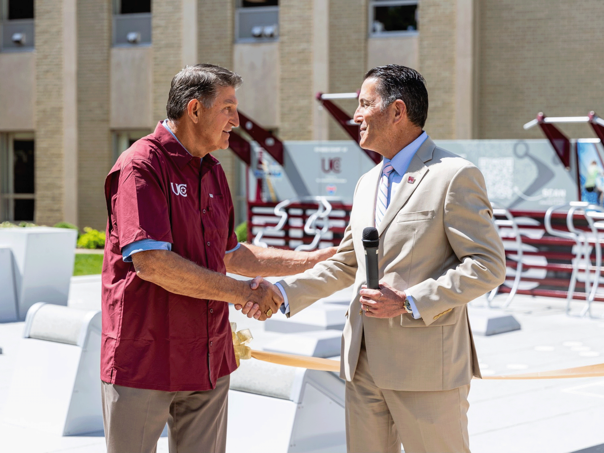 City and healthcare partner representatives shaking hands after securing an outdoor fitness grant