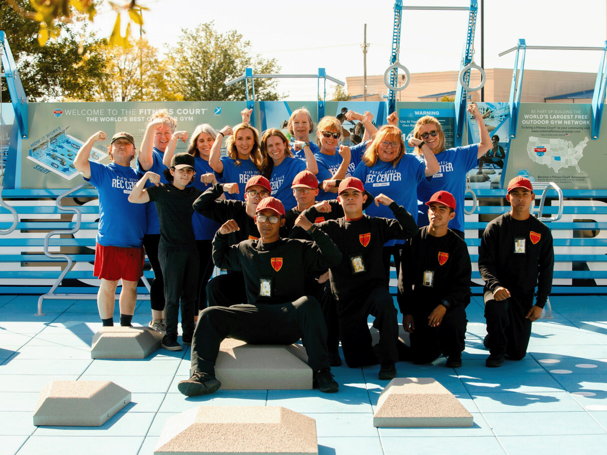 Recreation center staff posing together outdoors near a Fitness Court