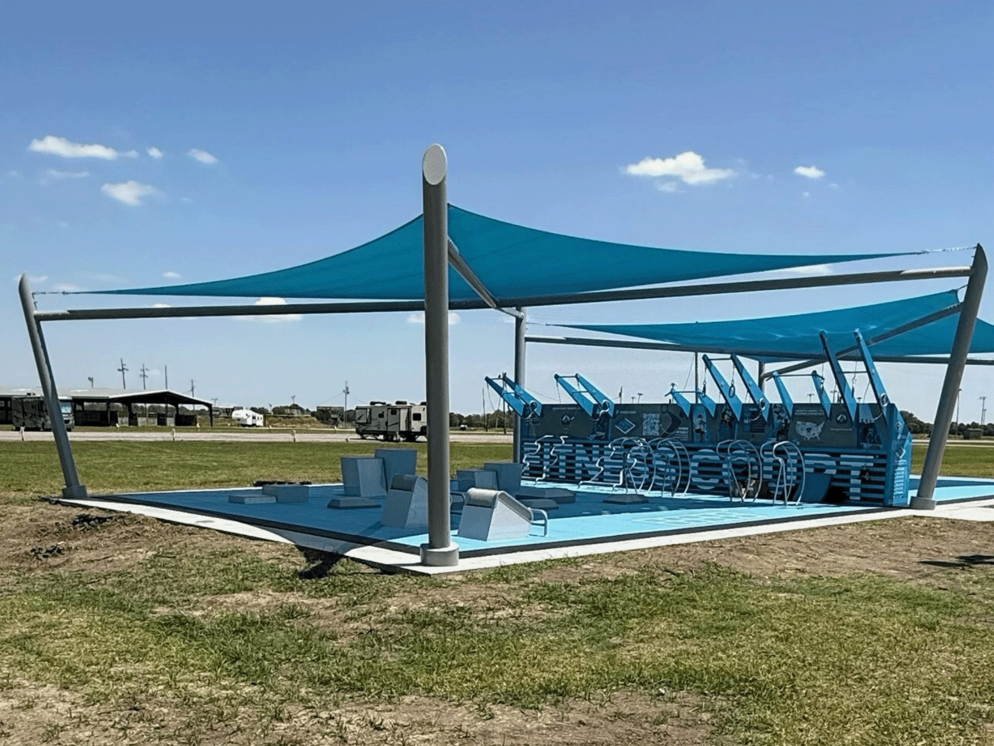 Fitness Court Shade structure providing sun protection over outdoor gym equipment