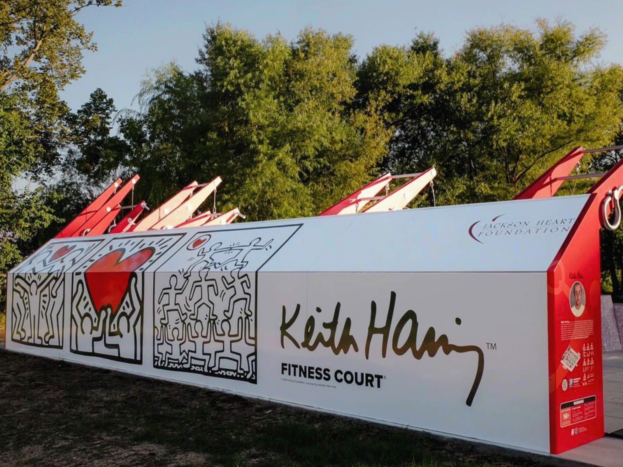 Custom Keith Haring artwork on a Fitness Court community identity wall