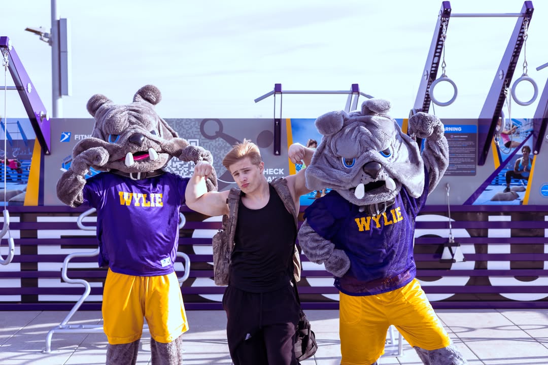 School mascots and a student posing together at a Fitness Court installation