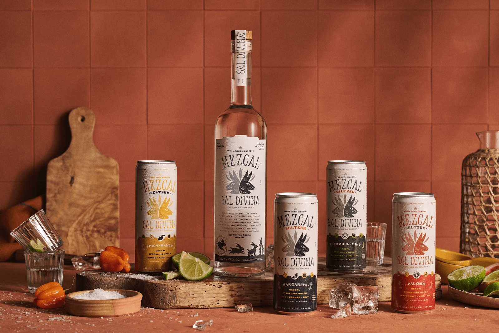 Four cans of Mezcal seltzers in various flavors and a tall bottle of Mezcal in the middle.