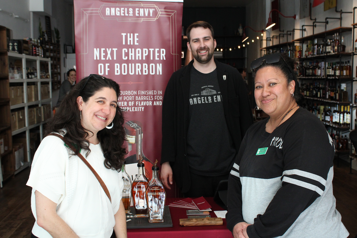 Julia Rubin and Elizabeth Tatola-Joachim pose with Joe Barwin, owner of Bitters and Bottles on Grand Avenue, SSF.