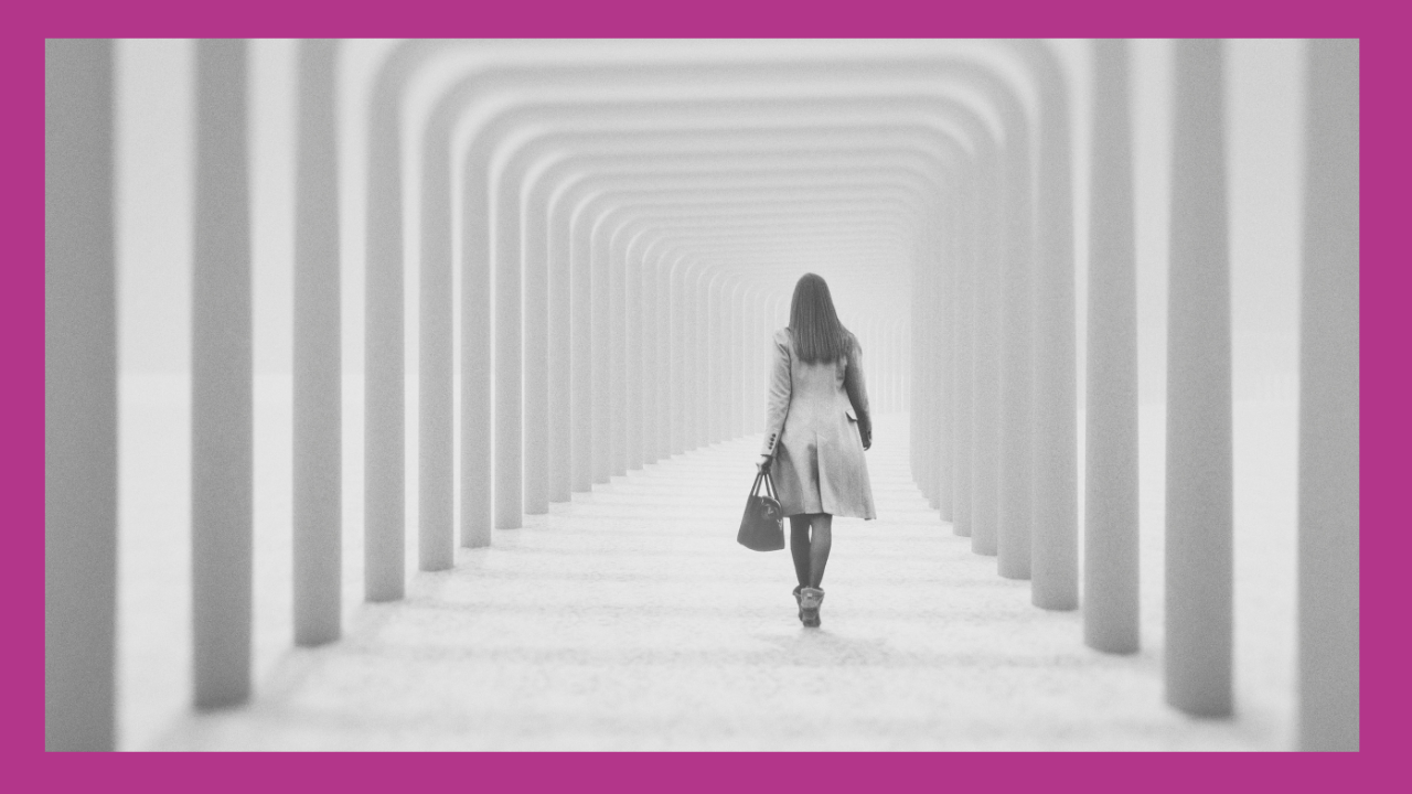 Woman in a long tunnel, walking away, back to camera