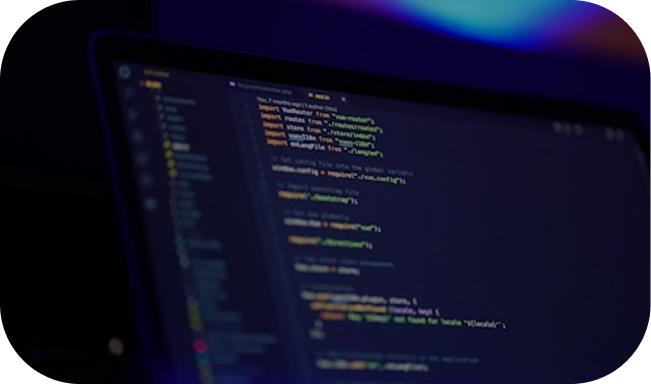 Laptop screen displaying blurred code in a dark-themed code editor with a blue and purple-lit background.