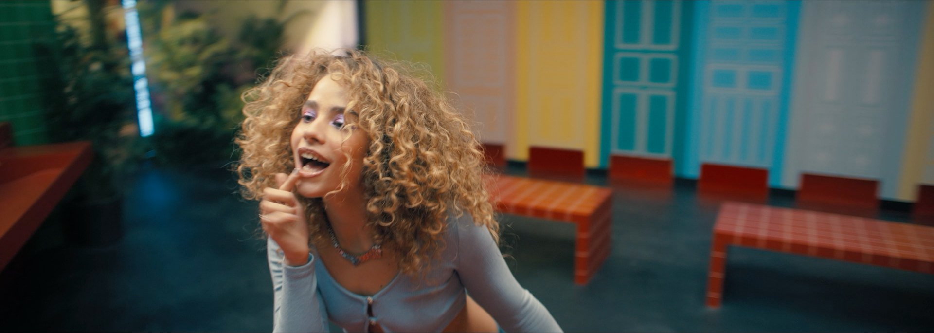 A woman laughs by the tiled benches