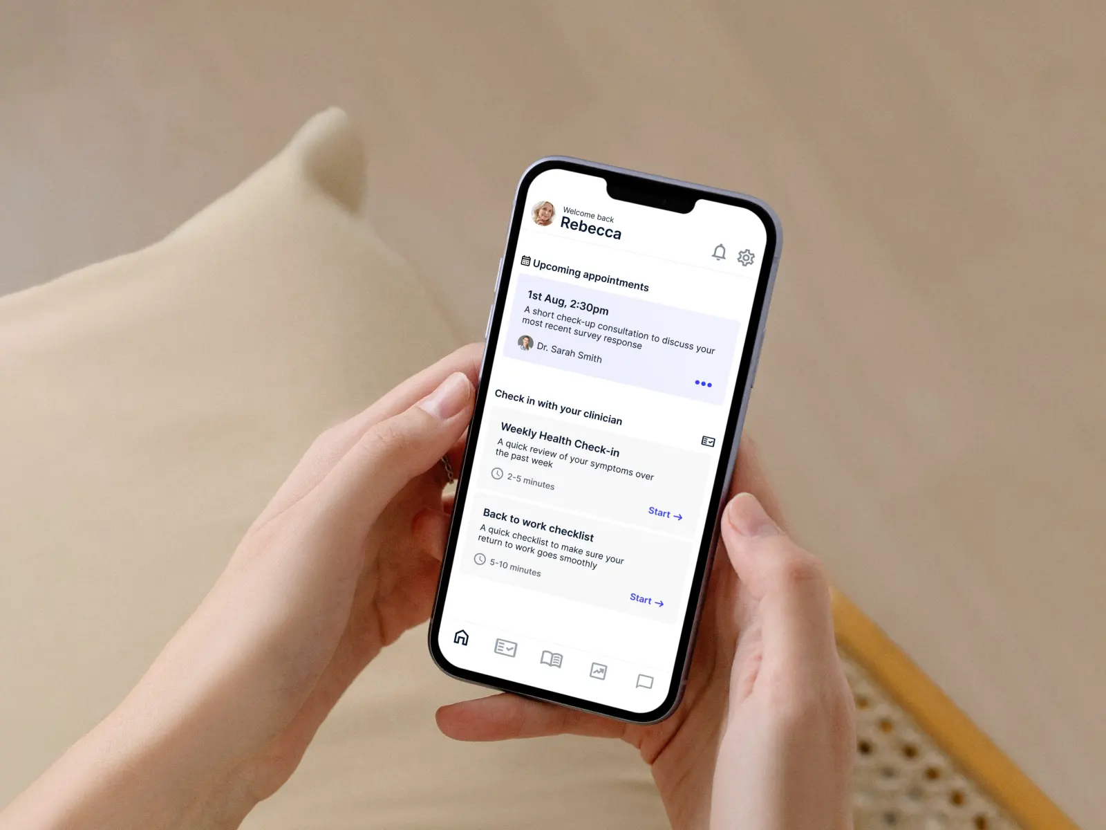 A person holding a mobile phone. The screen shows a remote health monitoring app dashboard for patients.