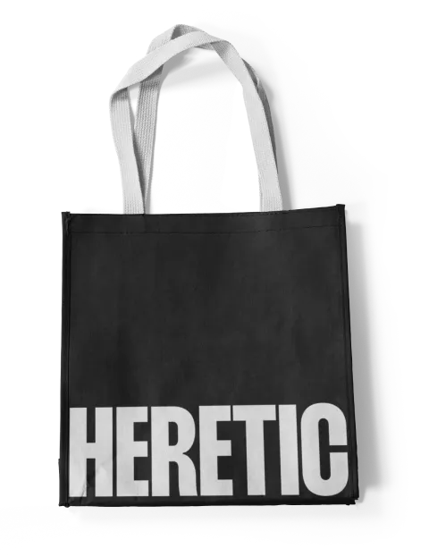 A black tote bag with a white "Heretic" logo on the front.