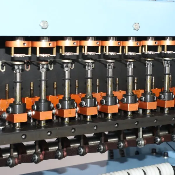 Close-up of cord knitting machine knitting head
