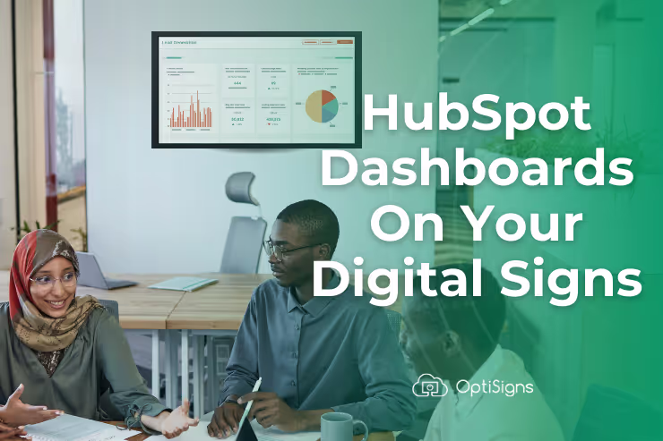 HubSpot dashboards displayed on a screen in an office space with people