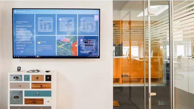 An office with a digital signage display showcasing company data.