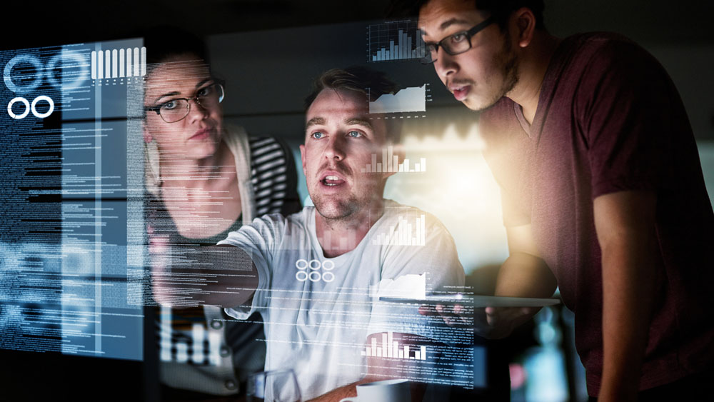Two men looking at a computer screen with images on it.