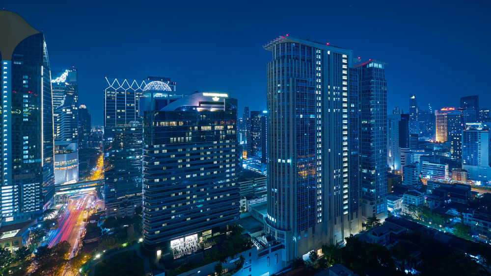 A city at night with a lot of tall buildings.