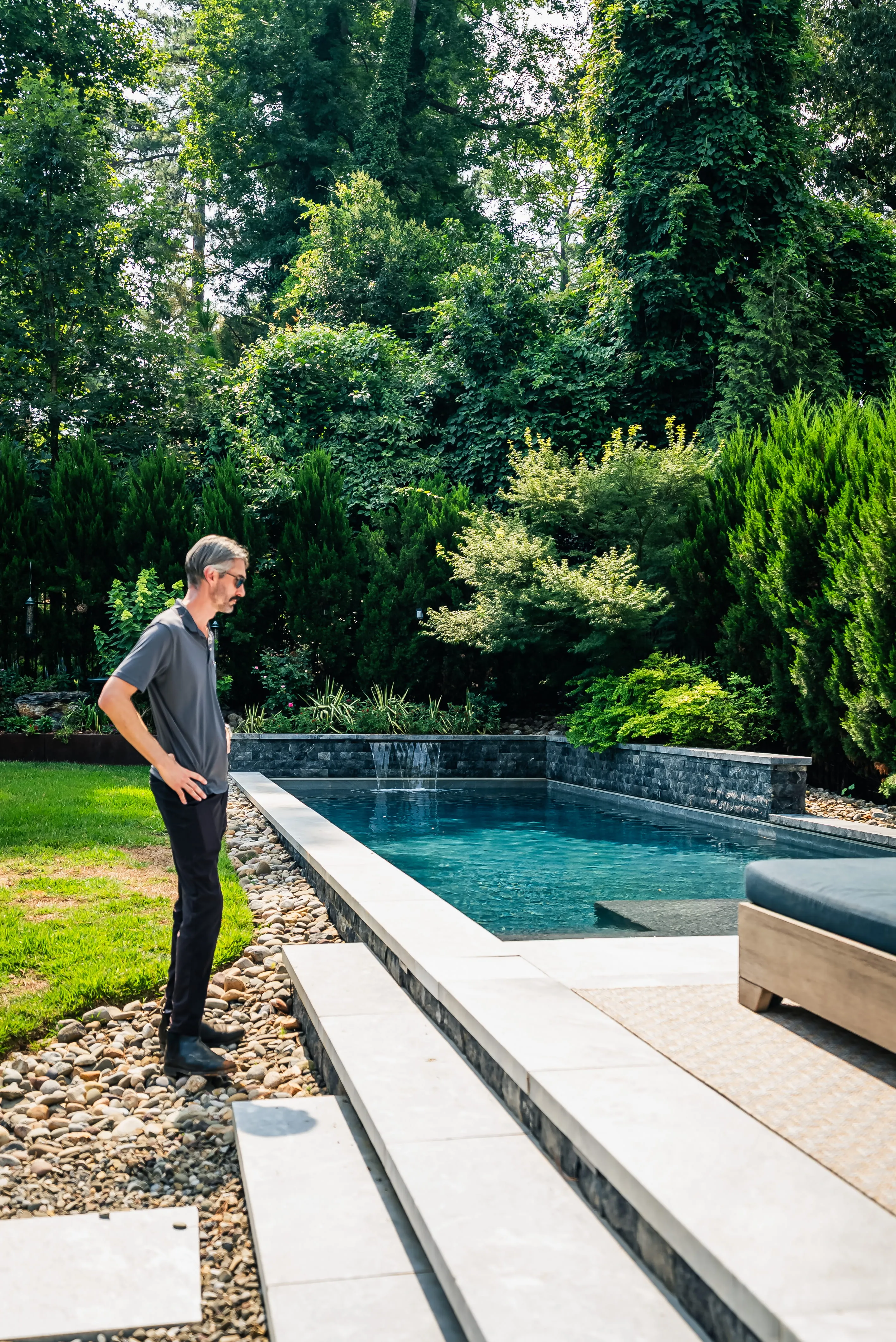 A Currin Outdoor Living team member overseeing the construction of a custom luxury swimming pool in a Raleigh, NC backyard.