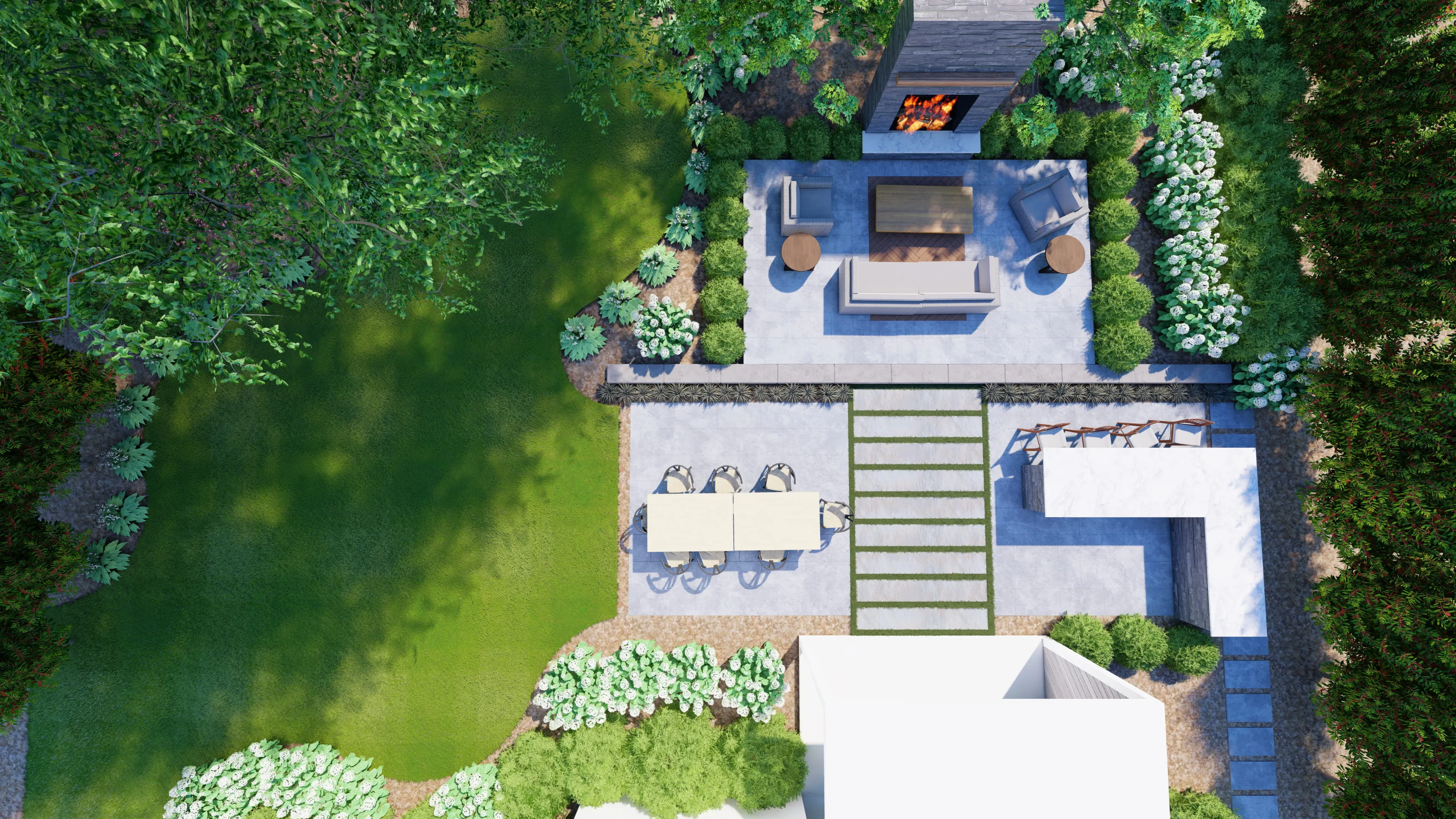A top-down aerial view of a luxury backyard renovation by Currin Outdoor Living, featuring a modern stone patio, integrated fire pit, and professional landscape design in Raleigh, NC.