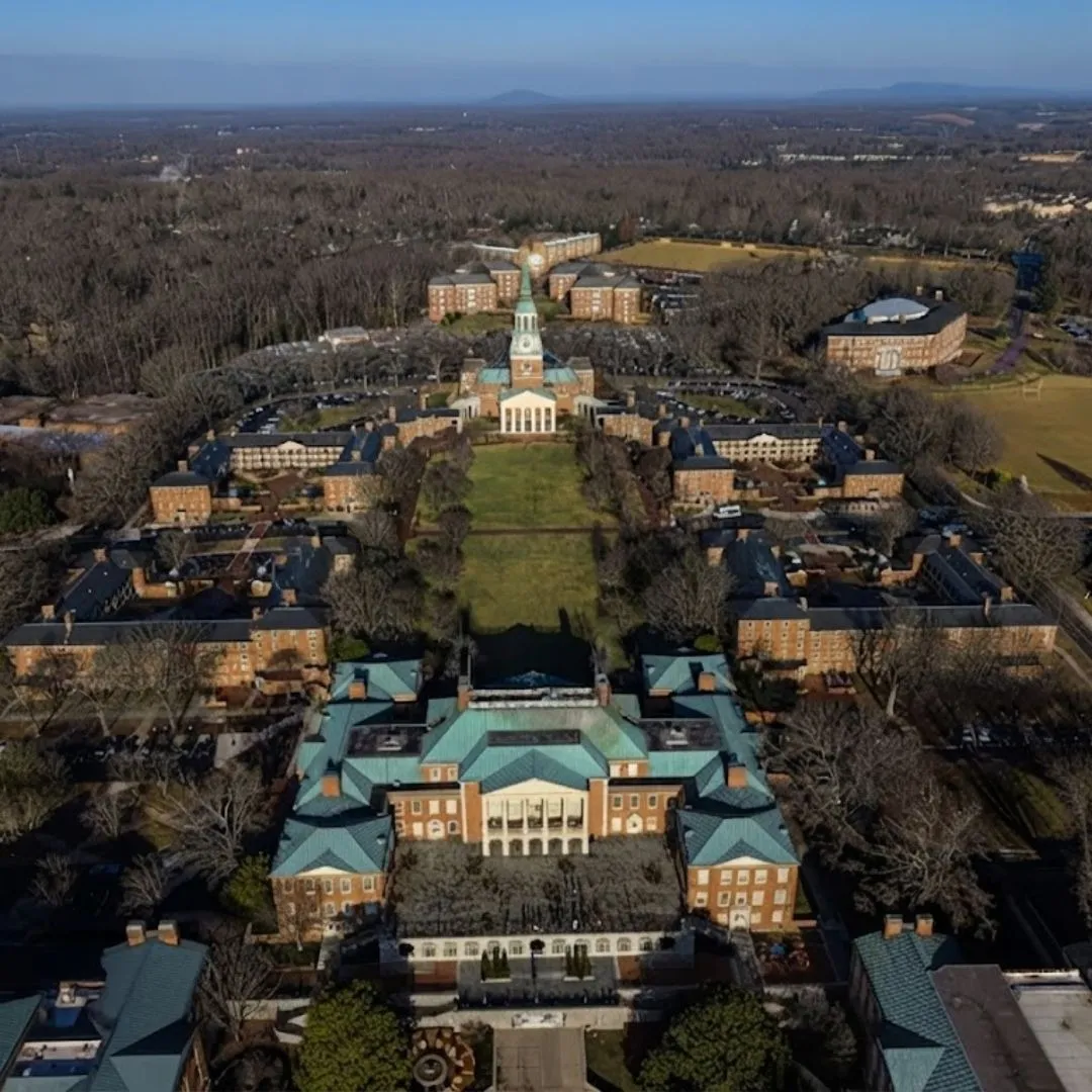 An aerial drone view of the historic North Carolina State Capitol building in Wake County, serving as a regional landmark near Wake Forest pool construction projects.