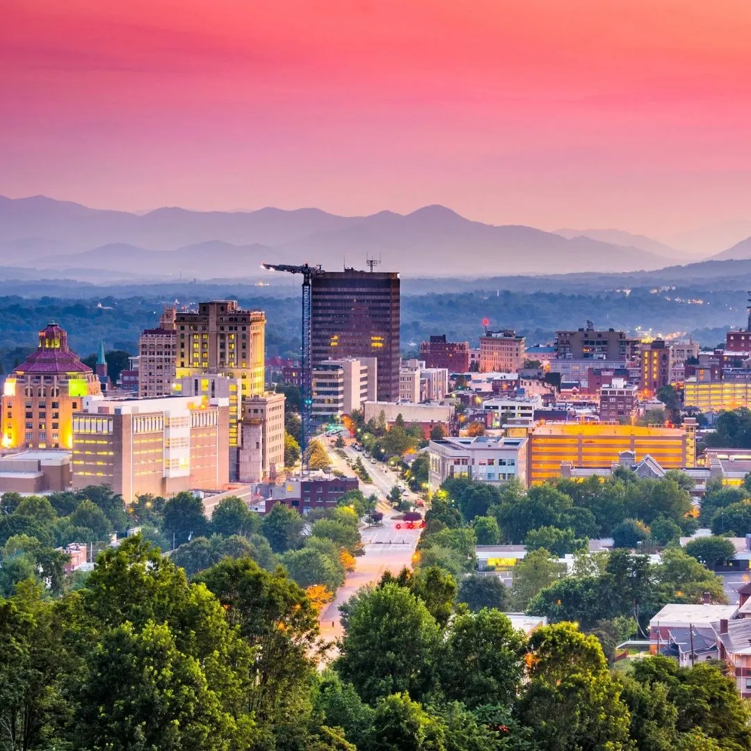 Aerial view of city skyline and urban landscape at sunset representing the Fuquay-Varina, NC service area for Currin Outdoor Living.