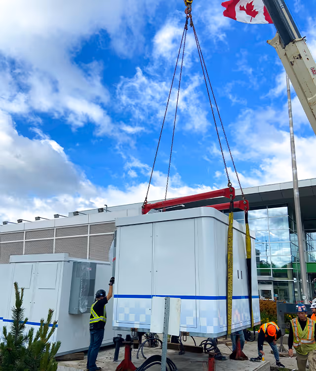 Jule's battery Hub being dropped into its designated area by a crane at a grocery store. 