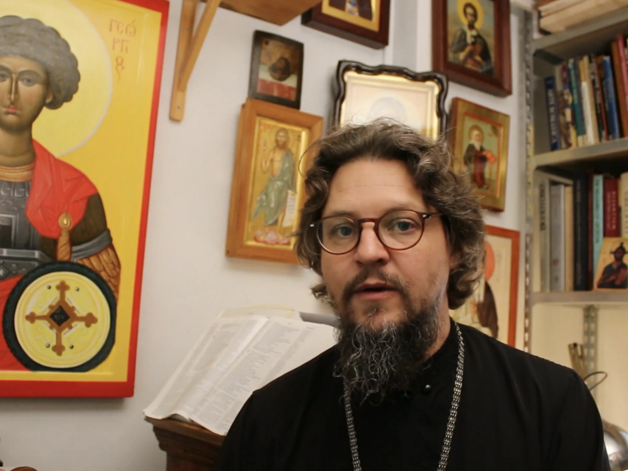 A video lesson from Icon Builder, the instructor teaching to camera beside a painted icon of Saint George