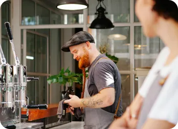 Cafe worker handing an order to a customer at the counter