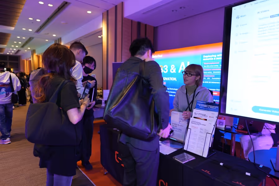 展示会でAlibaba Cloudのブースで話を聞く複数の人々。