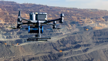 Drone with echo sounder sensor flying low over a lake for bathymetric mapping