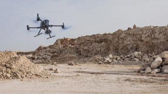 Drone with magnetometer flying a survey over a designated GET stockpile