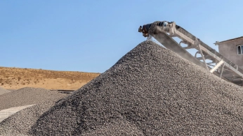 Conveyor stacker building a ROM ore stockpile
