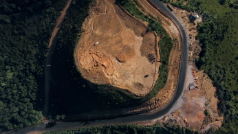 Researchers configuring a drone-mounted sensor system on a field worktable