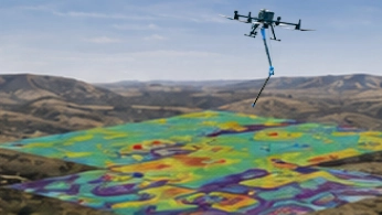 Researchers configuring a drone-mounted sensor system on a field worktable