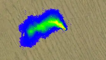 Drone carrying a magnetometer sensor surveying an archaeological site