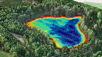 Researchers configuring a drone-mounted sensor system on a field worktable