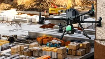 Drone carrying a magnetometer sensor surveying an archaeological site