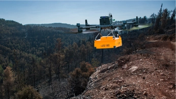 Drone equipped with ground-penetrating radar flying over a snow-covered glacier