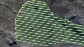 Drone carrying a magnetometer sensor surveying an archaeological site